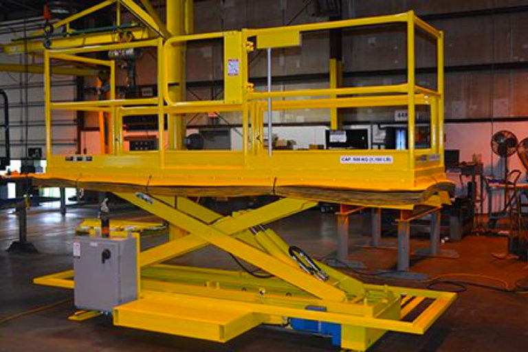 yellow platform lift being raised - custom lifts for automated manufacturing - Autoquip