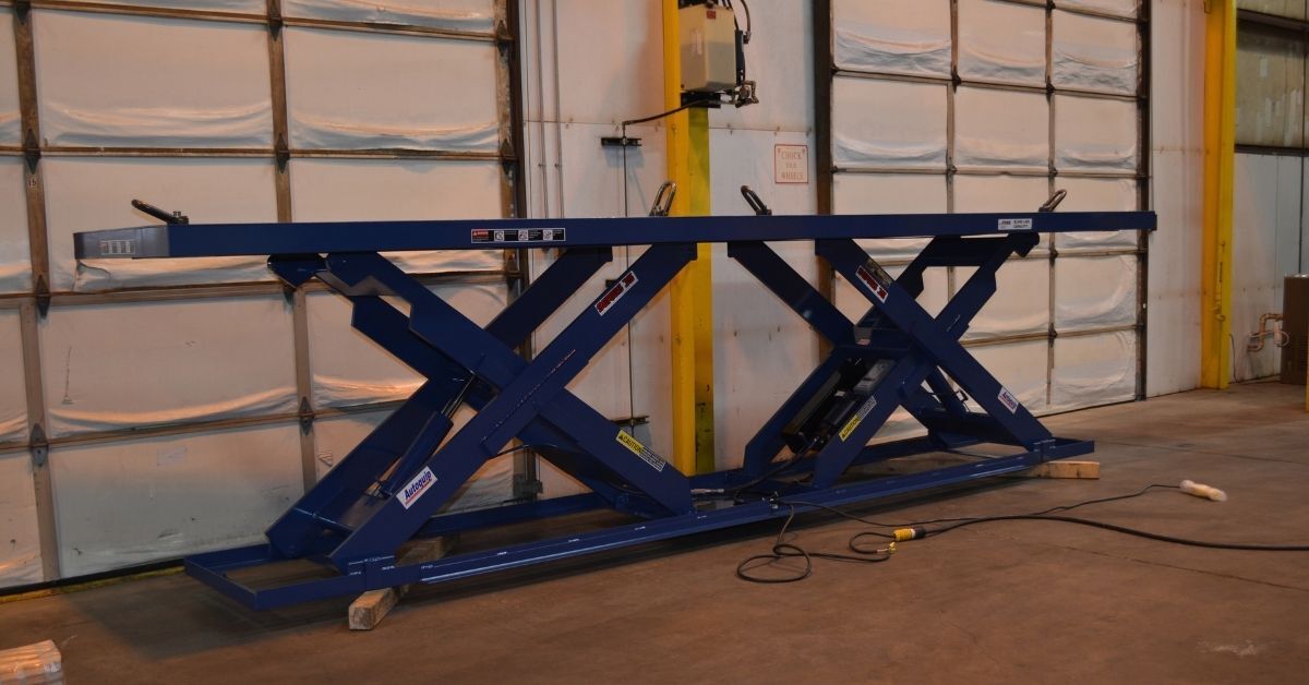 Autoquip industrial scissor lift table at a manufacturing facility